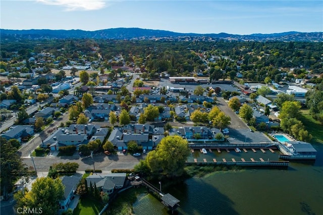 birds eye view of property featuring a water and mountain view and a residential view