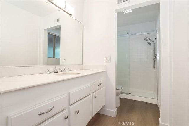 26144 Rainbow Glen Dr, Newhall, CA 91321 - full bathroom with vanity, toilet, a shower stall, visible vents, and wood finished floors