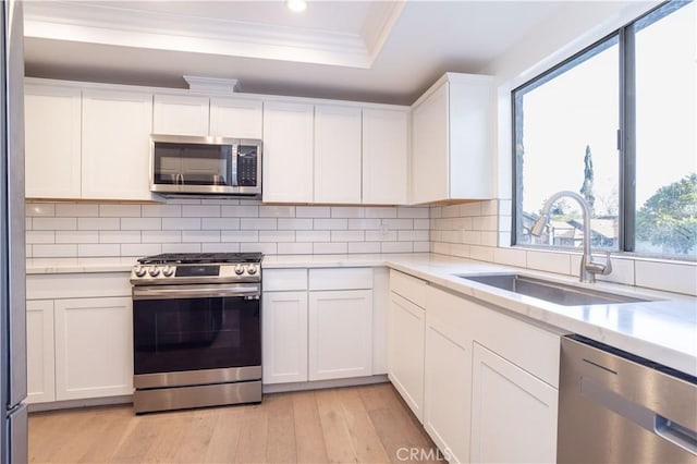 26144 Rainbow Glen Dr, Newhall, CA 91321 - kitchen featuring a sink, light countertops, appliances with stainless steel finishes, light wood-style floors, and recessed lighting