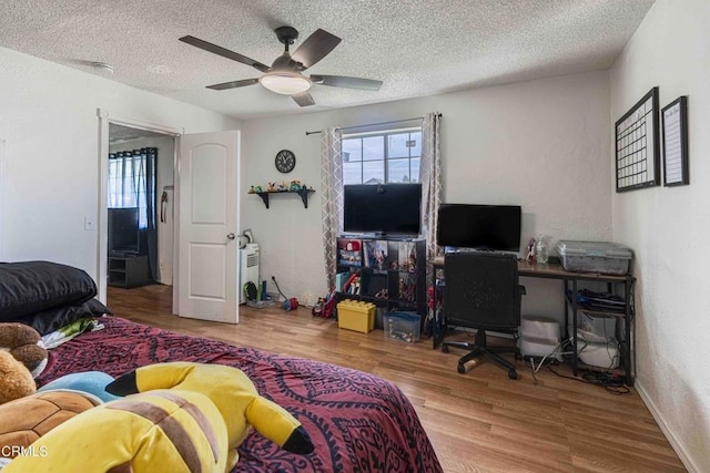 510 Decatur St, Bakersfield, CA 93308 - bedroom with a textured wall, a textured ceiling, a ceiling fan, and wood finished floors