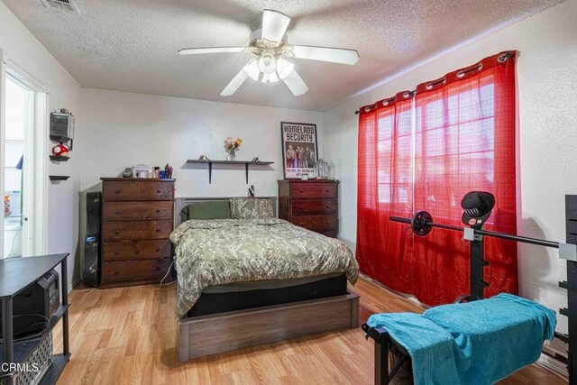 510 Decatur St, Bakersfield, CA 93308 - bedroom featuring visible vents, a textured ceiling, a ceiling fan, and wood finished floors