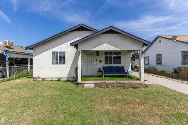 510 Decatur St, Bakersfield, CA 93308 - bungalow featuring stucco siding, fence, a front lawn, and outdoor lounge area