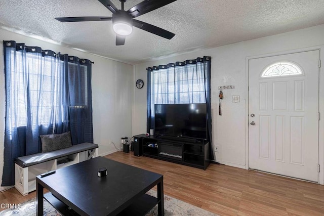 510 Decatur St, Bakersfield, CA 93308 - living room with light wood finished floors, a textured ceiling, and a ceiling fan