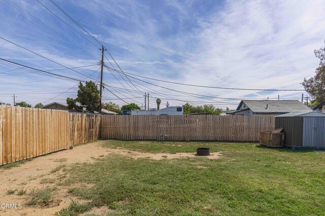 510 Decatur St, Bakersfield, CA 93308 - view of yard featuring a shed, a fenced backyard, and an outdoor structure