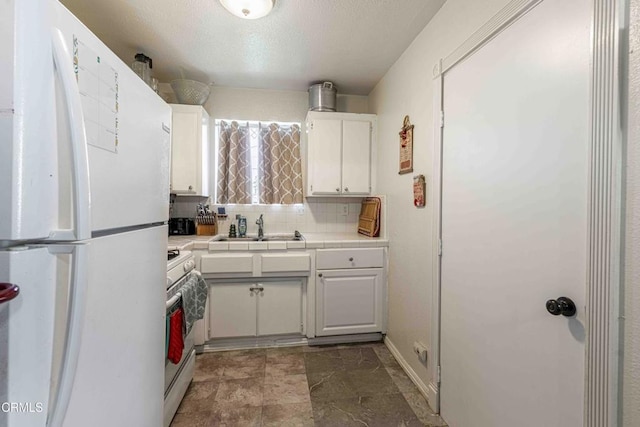 510 Decatur St, Bakersfield, CA 93308 - kitchen with tile countertops, white appliances, tasteful backsplash, white cabinets, and a sink