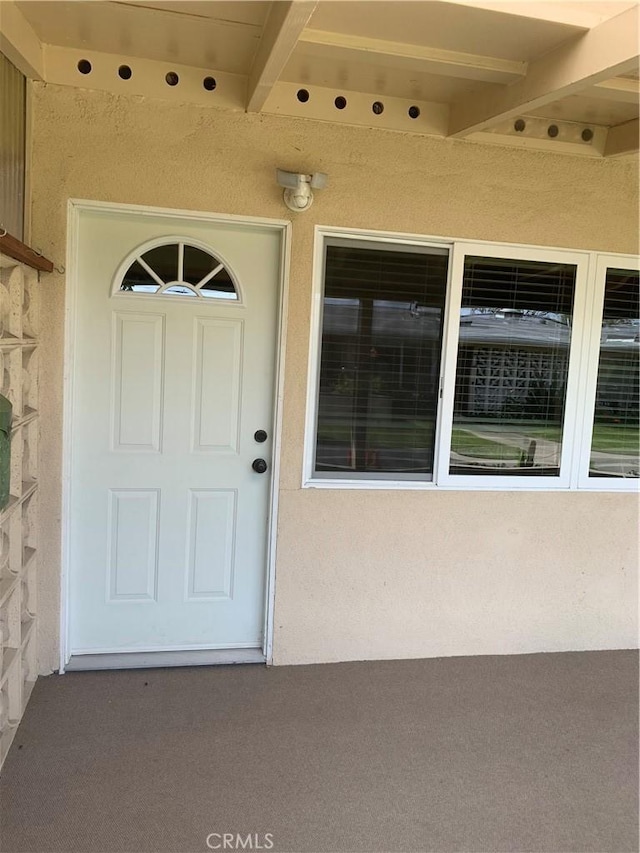 1441 Homewood Rd Unit M5-96B, Seal Beach, CA 90740 - view of exterior entry featuring stucco siding