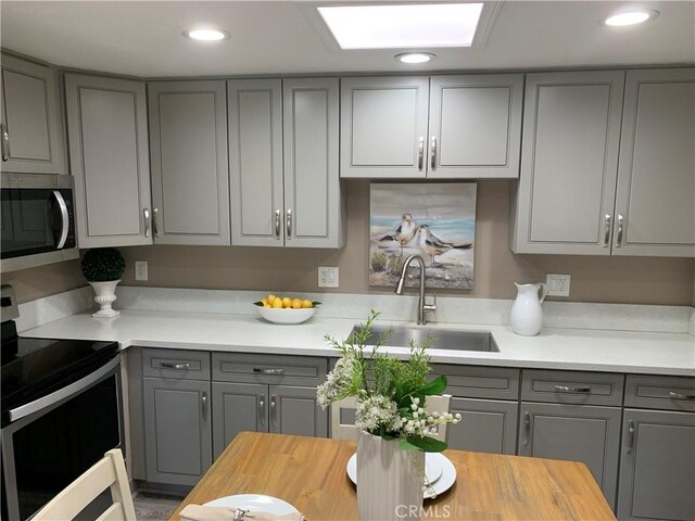 1441 Homewood Rd Unit M5-96B, Seal Beach, CA 90740 - kitchen with gray cabinetry, stainless steel appliances, a sink, butcher block countertops, and recessed lighting