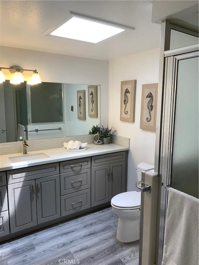 1441 Homewood Rd Unit M5-96B, Seal Beach, CA 90740 - full bathroom with toilet, vanity, and wood finished floors