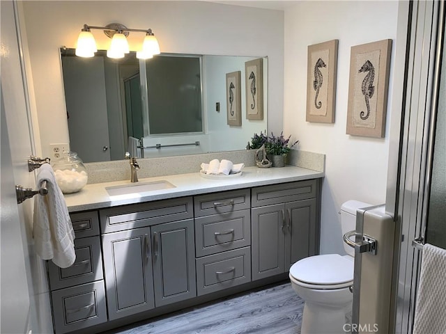 1441 Homewood Rd Unit M5-96B, Seal Beach, CA 90740 - full bath featuring toilet, vanity, an enclosed shower, and wood finished floors