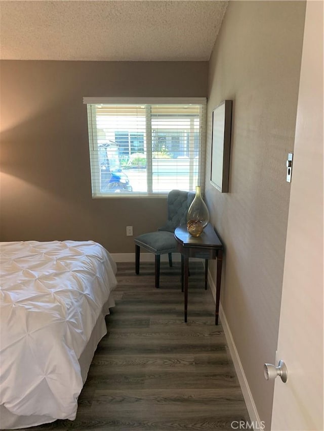 1441 Homewood Rd Unit M5-96B, Seal Beach, CA 90740 - bedroom featuring a textured ceiling, baseboards, and dark wood-style flooring