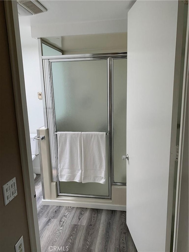 1441 Homewood Rd Unit M5-96B, Seal Beach, CA 90740 - full bathroom featuring wood finished floors and a shower with door
