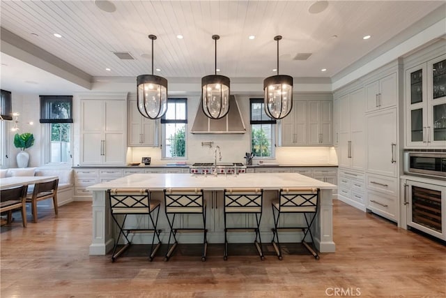 617 Anderson St, Manhattan Beach, CA 90266 - kitchen with stainless steel microwave, plenty of natural light, a large island, and wine cooler