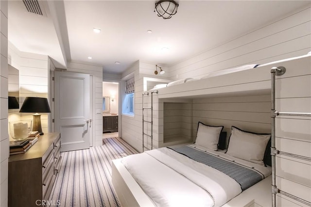 617 Anderson St, Manhattan Beach, CA 90266 - bedroom featuring visible vents, wood walls, ensuite bath, and light carpet
