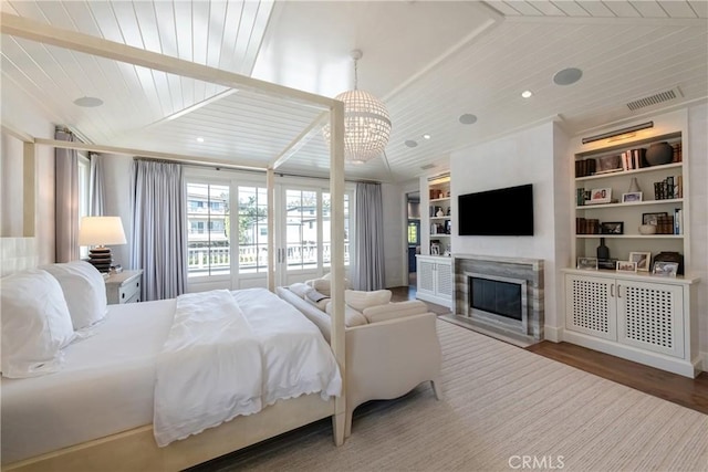 617 Anderson St, Manhattan Beach, CA 90266 - bedroom with visible vents, a chandelier, wood ceiling, wood finished floors, and a fireplace with flush hearth