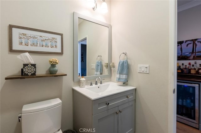 bathroom with vanity, toilet, and beverage cooler