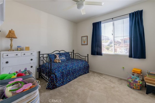 carpeted bedroom with a ceiling fan and baseboards