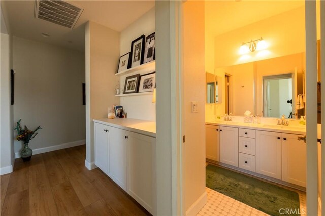 18182 Bissel Dr, Riverside, CA 92508 - corridor featuring dark wood-type flooring, a sink, and baseboards
