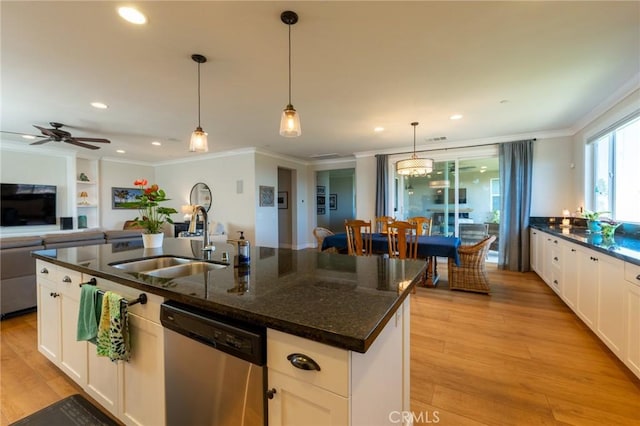 kitchen with an island with sink, stainless steel dishwasher, a sink, crown molding, and white cabinetry