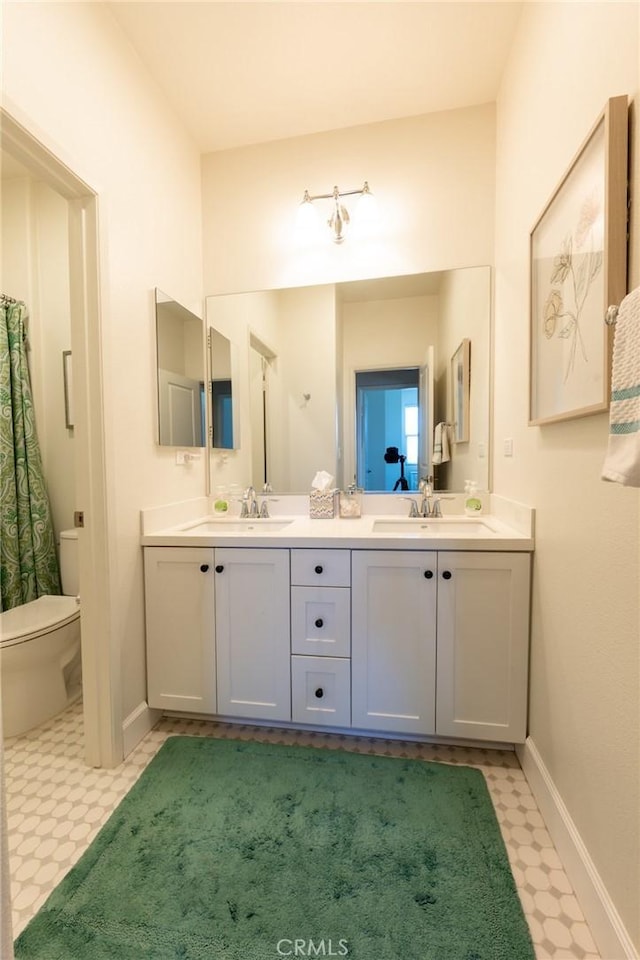 full bathroom with tile patterned floors, a sink, and double vanity