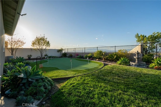 surrounding community with a fenced backyard and a lawn