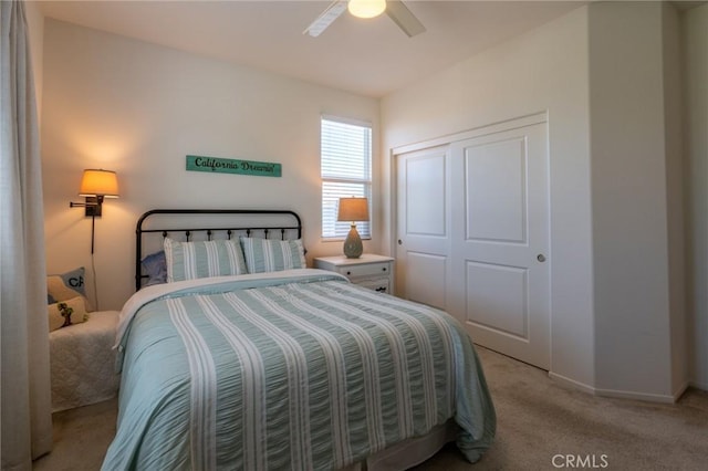 bedroom with light carpet, baseboards, a closet, and ceiling fan