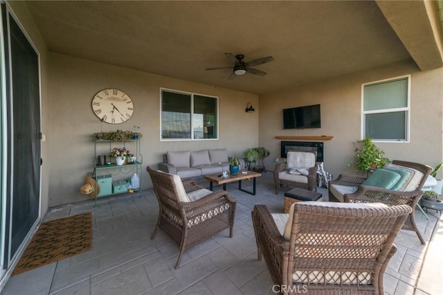 view of patio / terrace with ceiling fan and an outdoor living space