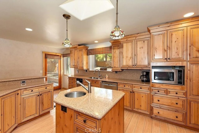 105 Olympic Dr, Big Bear Lake, CA 92315 - kitchen with stainless steel appliances, light stone countertops, an island with sink, and a sink