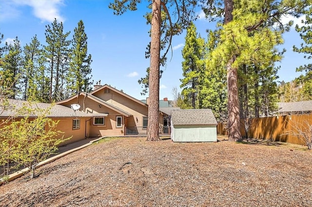 105 Olympic Dr, Big Bear Lake, CA 92315 - back of house featuring a fenced backyard, a storage unit, and an outdoor structure