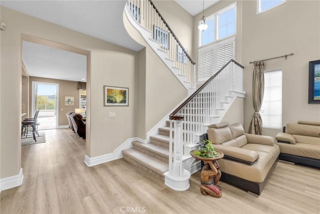 2 Aquila Way, Coto De Caza, CA 92679 - stairs featuring wood finished floors, baseboards, and a high ceiling