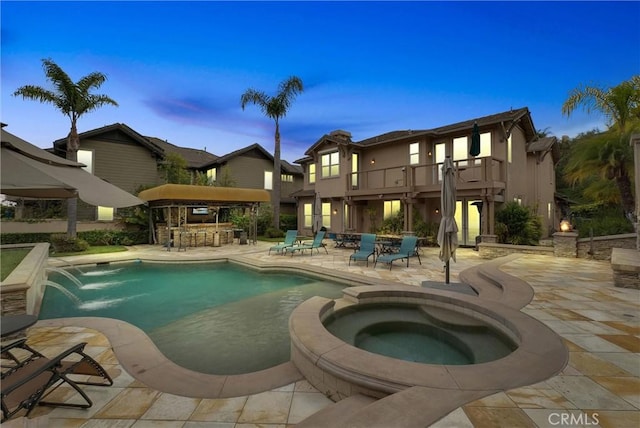 2 Aquila Way, Coto De Caza, CA 92679 - pool at dusk featuring a patio area and a pool with connected hot tub