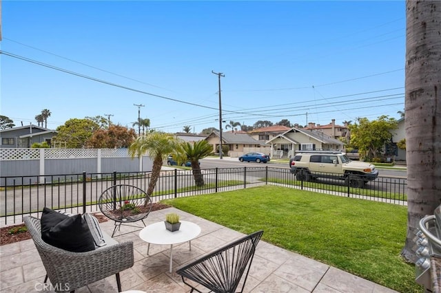 view of patio featuring a residential view and fence