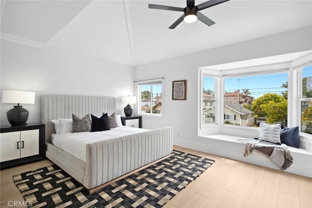 bedroom featuring high vaulted ceiling, a ceiling fan, and wood finished floors