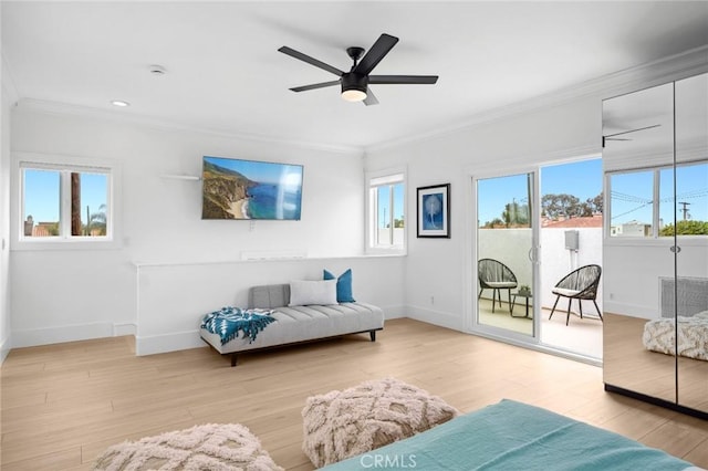 living area featuring crown molding, a wealth of natural light, and baseboards