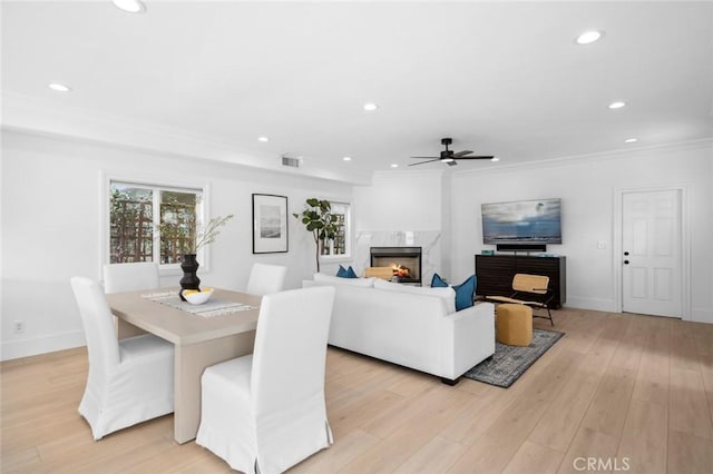 dining room featuring visible vents, ceiling fan, light wood-style floors, a fireplace, and recessed lighting