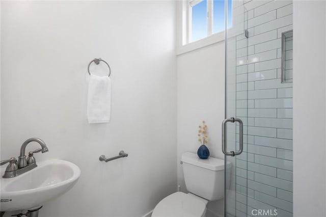 full bath with a shower stall, a sink, and toilet