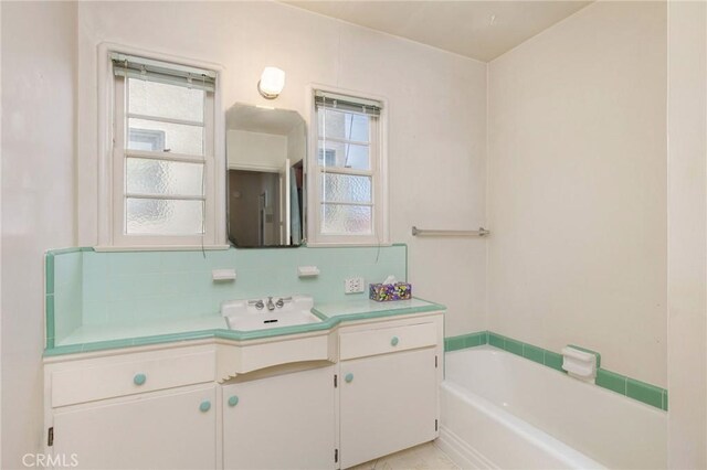 3515 E 1st St, Long Beach, CA 90803 - bathroom with a wealth of natural light, vanity, a garden tub, and decorative backsplash