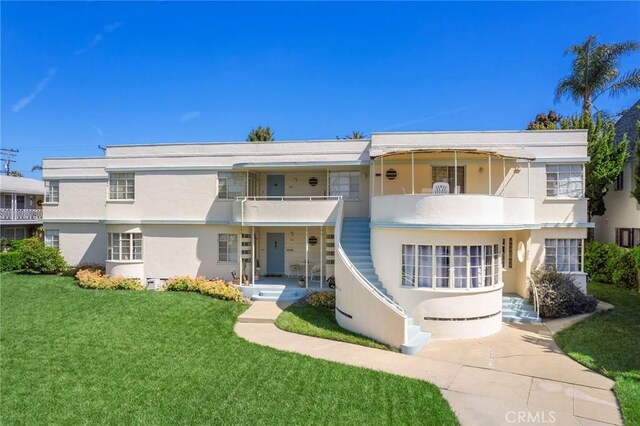 3515 E 1st St, Long Beach, CA 90803 - art deco inspired home featuring a front lawn, a balcony, and stucco siding