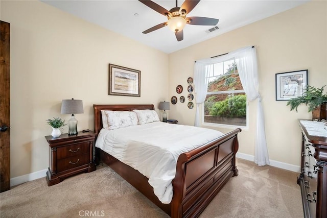bedroom featuring ceiling fan, light colored carpet, baseboards, and visible vents