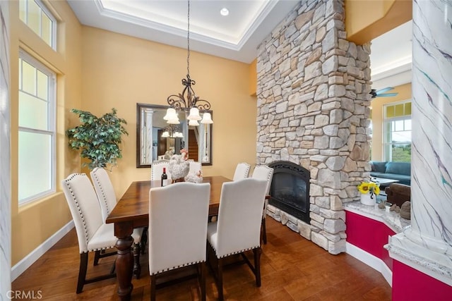 162 Valley View Pl, Arroyo Grande, CA 93420 - dining space featuring a chandelier, wood finished floors, a stone fireplace, a ceiling fan, and a tray ceiling