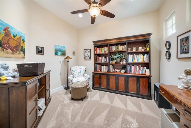 living area featuring baseboards, recessed lighting, light colored carpet, and a ceiling fan