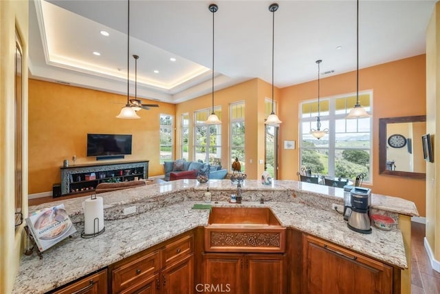 162 Valley View Pl, Arroyo Grande, CA 93420 - kitchen with light stone countertops, brown cabinets, ceiling fan, and recessed lighting