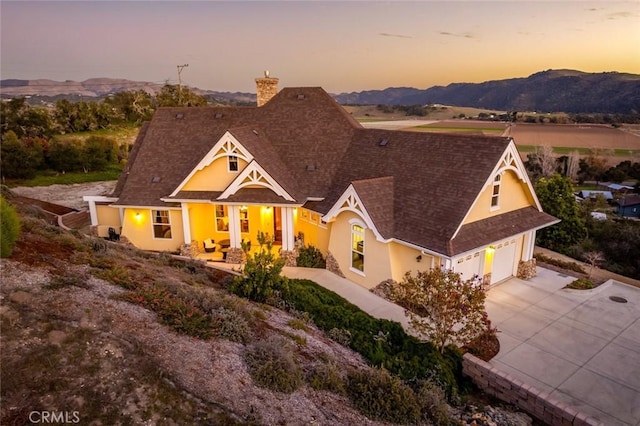 162 Valley View Pl, Arroyo Grande, CA 93420 - view of front of property featuring a chimney, driveway, roof with shingles, stucco siding, and a mountain view