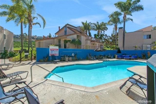 pool featuring a patio and fence