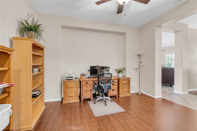 office area featuring ceiling fan, wood finished floors, and baseboards
