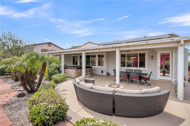 view of patio featuring an outdoor living space, french doors, an outdoor kitchen, and ceiling fan