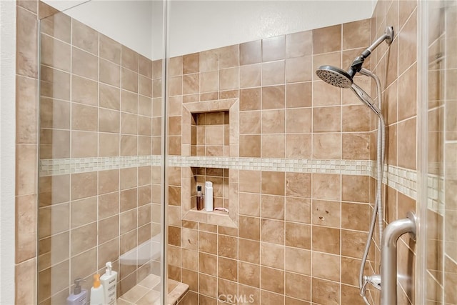 full bath featuring a tile shower