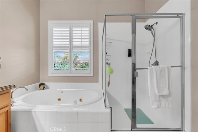 bathroom with a whirlpool tub and a stall shower