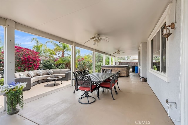 view of patio / terrace with outdoor dining area, outdoor lounge area, a hot tub, and ceiling fan