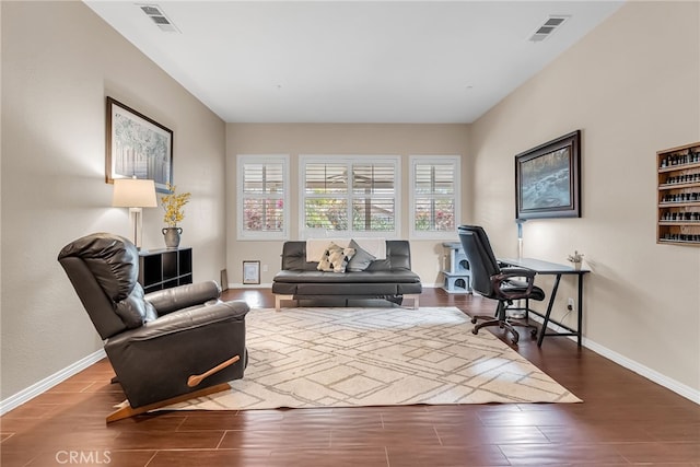 sitting room featuring wood finished floors, baseboards, and visible vents
