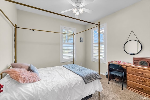 bedroom with baseboards, ceiling fan, and light carpet